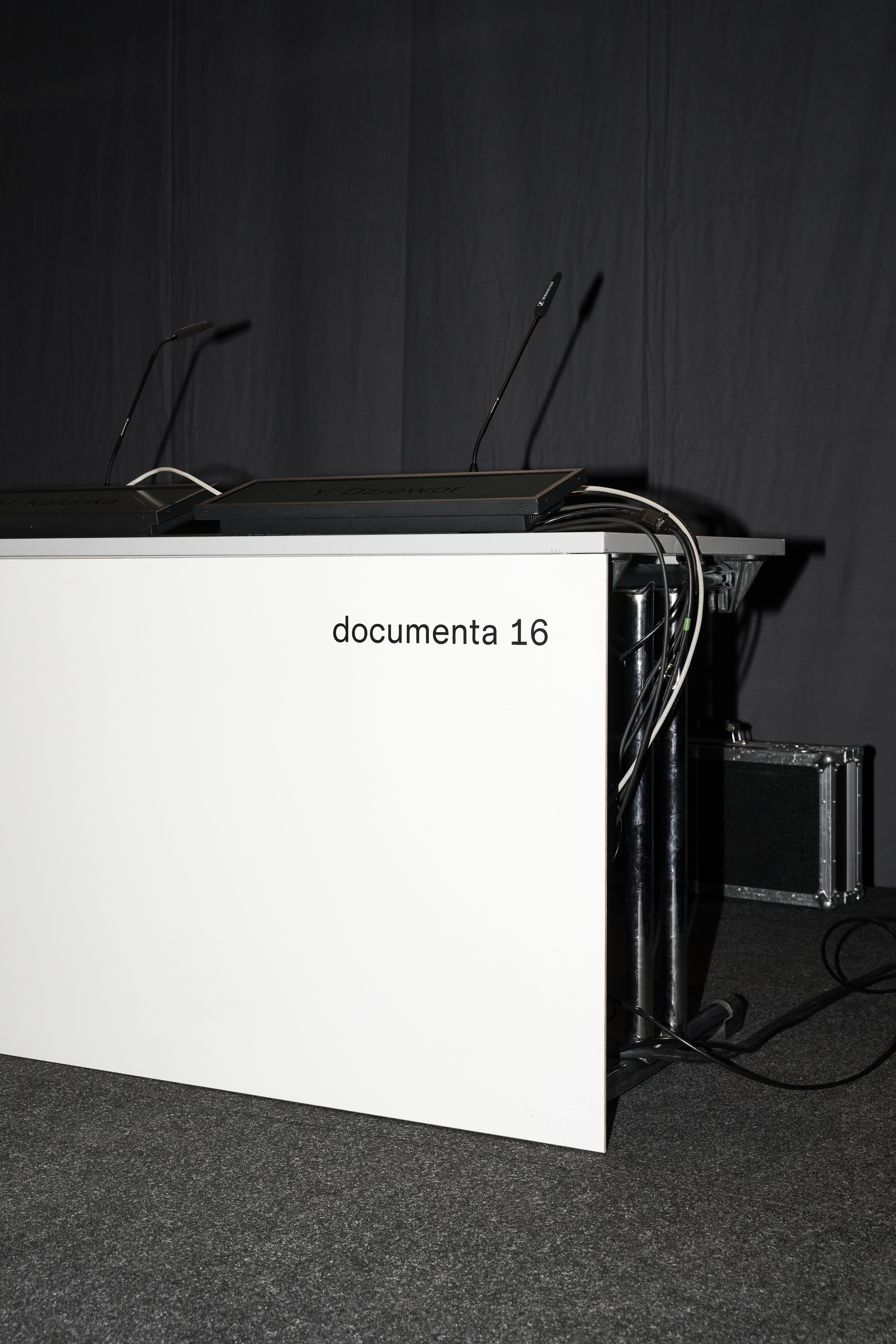 A speakers podium can be seen, on the front is written documenta 16